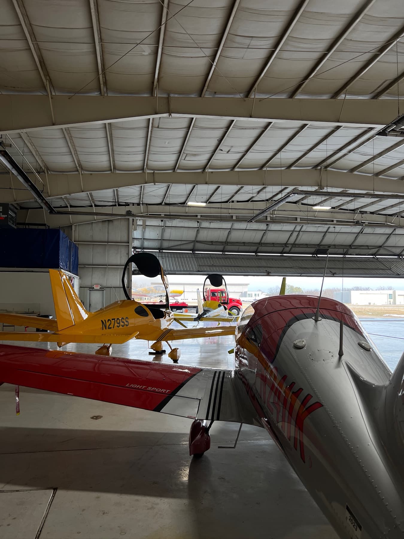 Aircraft parked wingtip to wingtip inside the hangar