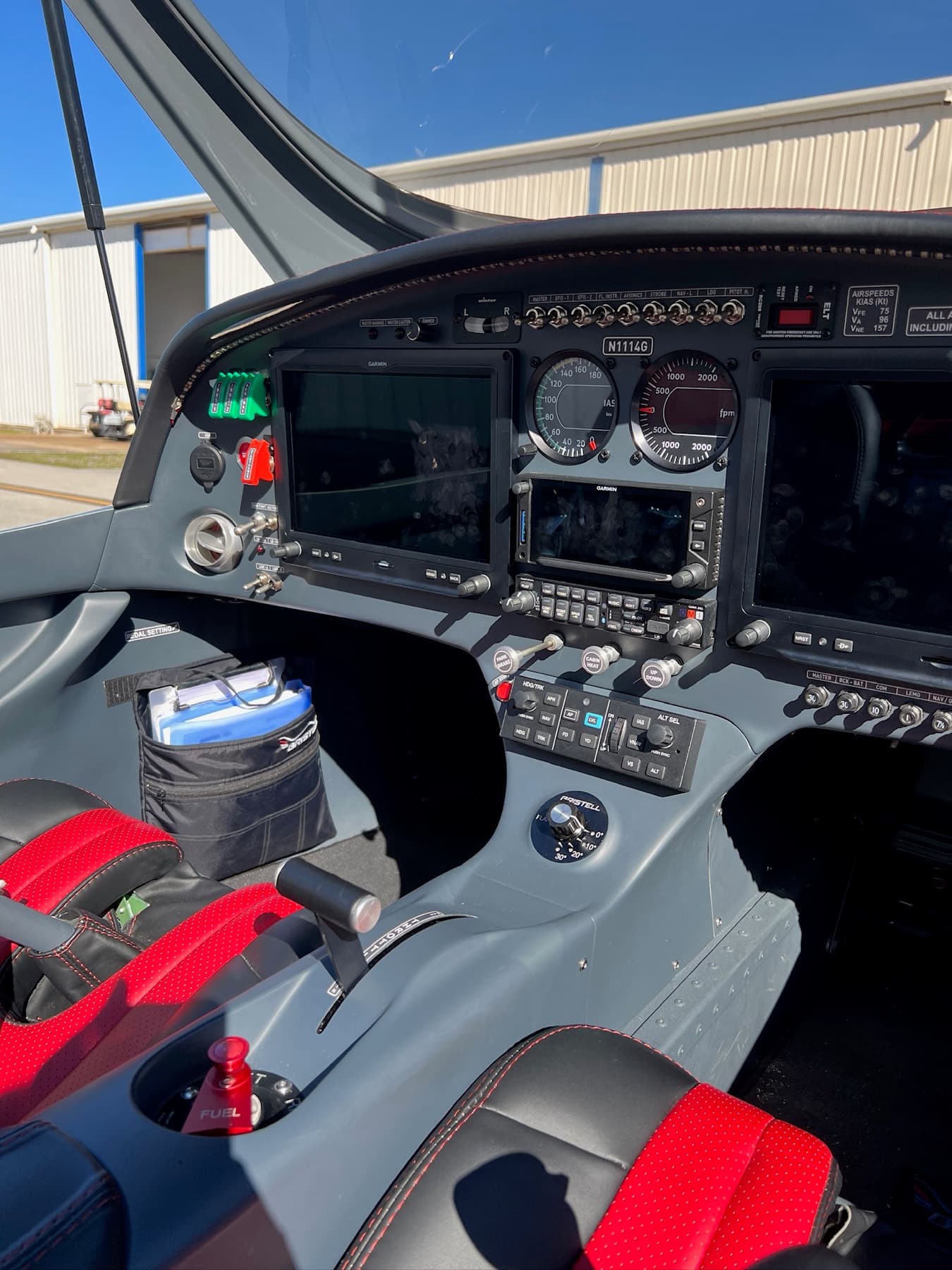 Glass cockpit panel and red leather seats of a Bristell