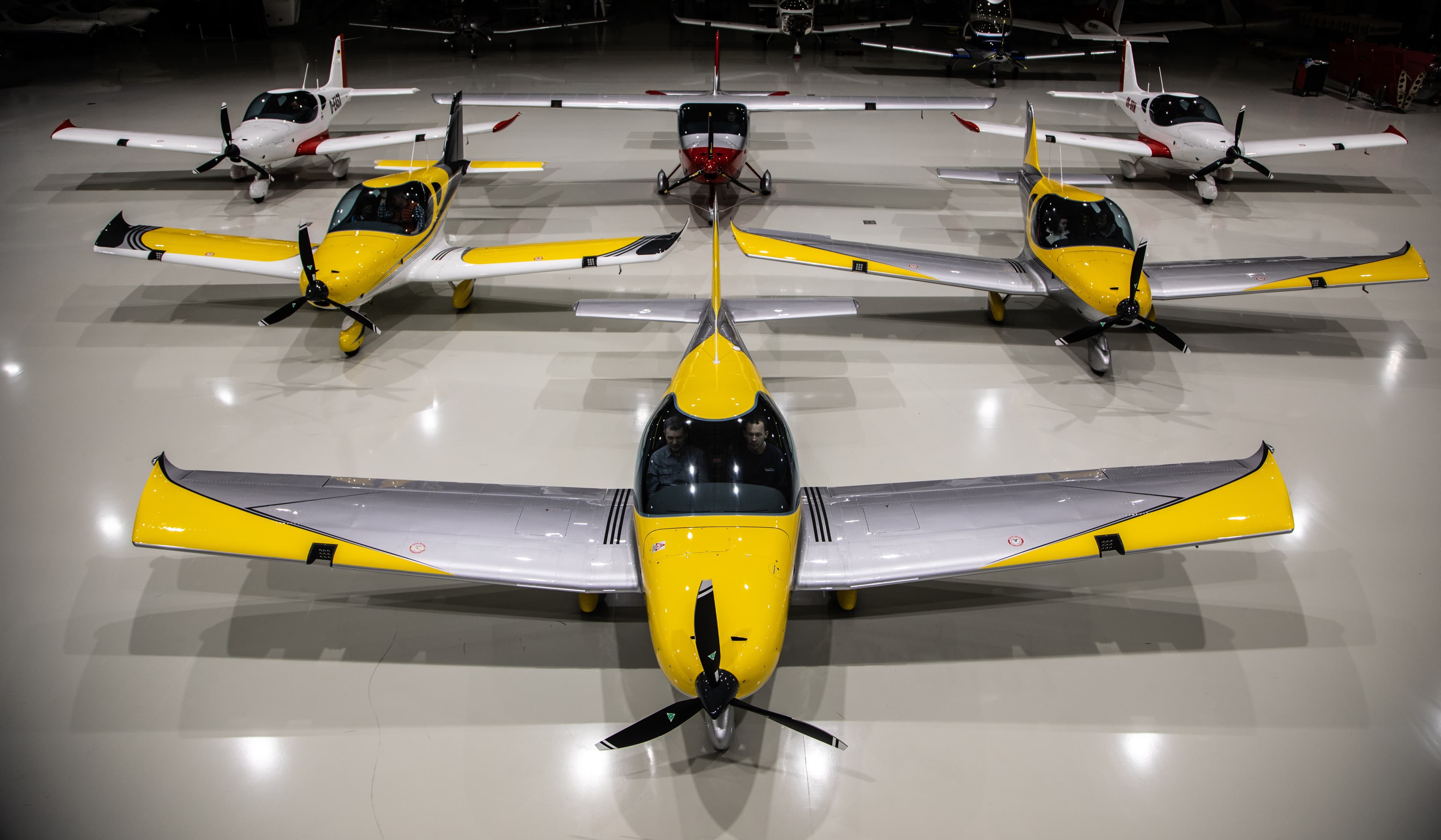 The yellow Bristell fleet lined up together inside the hangar