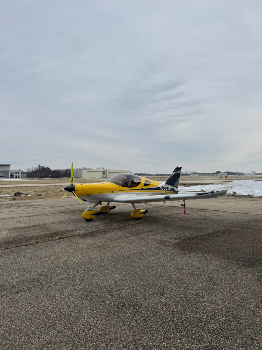 A yellow Bristell on the ramp at Waukegan National Airport