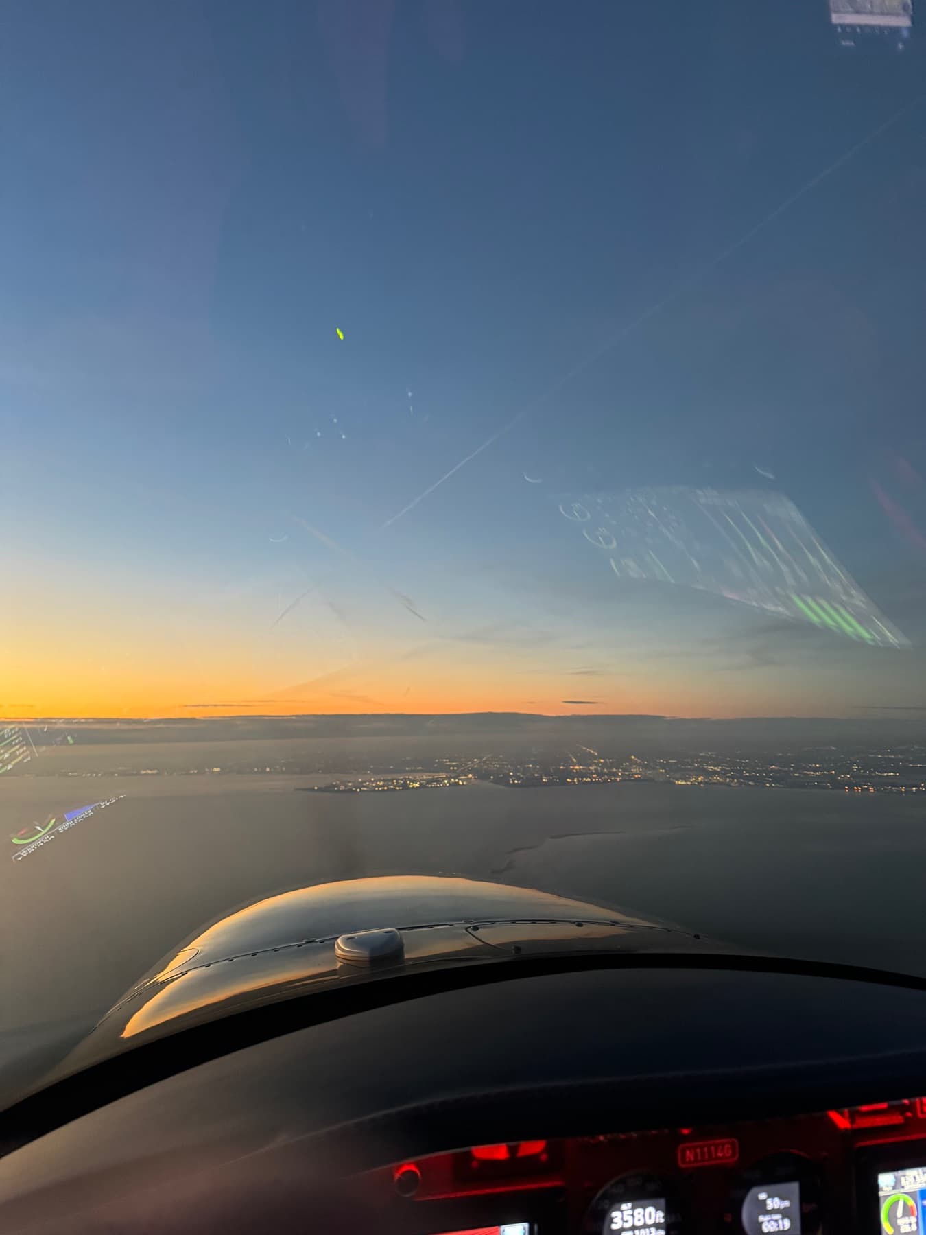 Sunrise from the cockpit, instrument panel glowing