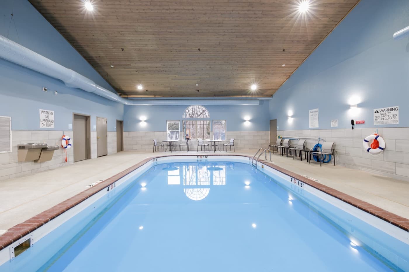 Indoor swimming pool with seating along one side